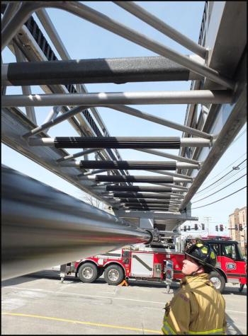 Lowe inspects under the extended ladder