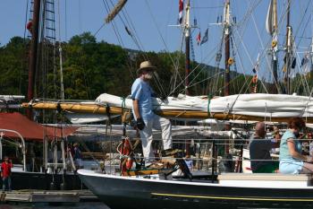 Capt. Jack Moore at the helm of schooner Surprise. (Photo by Holly S. Edwards)