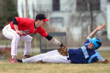 Oceanside’s Riley Sprague slides into third base where Camden Hills Chandler Crans applies the tag, but Sprague was called safe as the umpire said he slid in under the high tag. Sprague scored what would become the winning run. (Photo by Ron Hawkes)