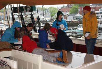 Furling canopies and covers aboard schooner Mary Day Wednesday morning in preparation for departure. (Photo by Holly S. Edwards)