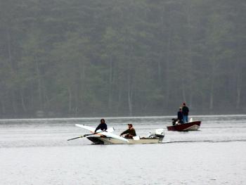 The missing rower’s sculling boat is carried back across Megunticook Lake. (Photo by Holly S. Edwards)