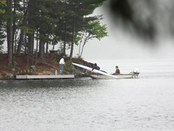 The missing rower’s scull boat is brought to shore. (Photo by Holly S. Edwards)