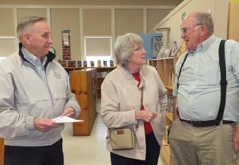 Thomas Malloy, his wife, Fay Malloy, and Tim Woodman share a moment coming into Owls Head Central School. Malloy is a former teacher at the school and Fay and Tim were classmates. (Photo by Chris Wolf)
