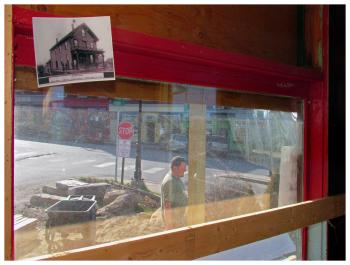 A 19th Century photo of the Ocean House Hotel hangs inside the front window of the same building, currently under renovation. (Photo by Ethan Andrews)