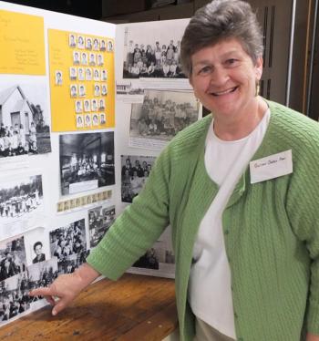 Susan Oakes-Cran finds her kindergarten picture. (Photo by Chris Wolf)