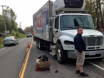 A fully loaded ice truck was unable to stop as it came around a corner and encountered a turning vehicle ahead of it.