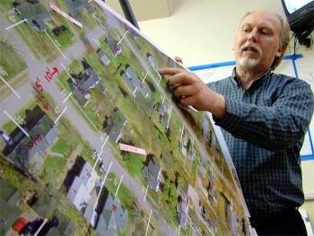 City Planner Wayne Marshall with detail from a map listing setback distances for all properties inside the bypass. These vary from streets where homes practically abut the road, to others where 50-foot-deep front lawns are the norm. One of several new zoning proposals would allow variable setbacks based on existing buildings. (Photo by Ethan Andrews)
