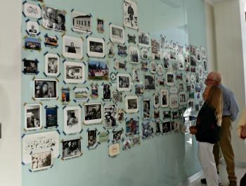The plexiglass wall in Bigelow Labs front hallways is filled with photos from Bigelow's 40-year history, including many staff Christmas cards. KATRINA CLARK/Boothbay Register