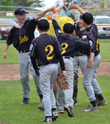 Several Fisher players celebrate their championship victory by dumping Gatorade onto manager John Murphy. (Photo by George Harvey)