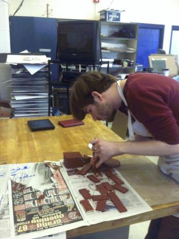 Wyatt Timchak paints parts of the mill. (Photo courtesy Russell Kahn)