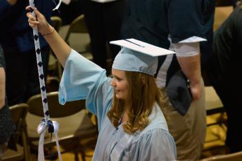 Senior class President Tabbitha Johnston leads the girls into the gym for their graduation exercise. (Photo by Ron Hawkes)
