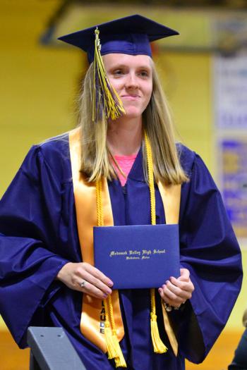 Haley Amber Mank looks pleased as can be to have her diploma in hand. (Photo by Ron Hawkes)