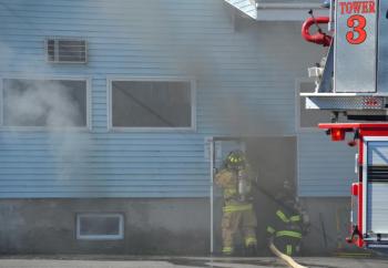 Rockland firefighters enter the burning building. (Photo by Lynda Clancy)