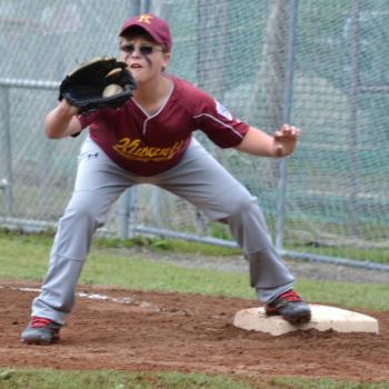 Ethan Carballo, of Kiwanis, receives the throw and therefore, gets the base runner out. (Photo by George Harvey)