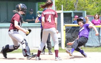 An Islanders player attempts to slide safely into home plate. (Photo by George Harvey)