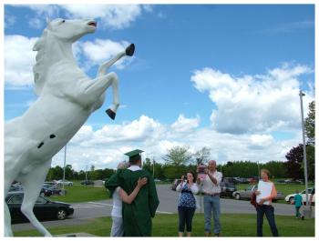 Many families posed by the Mount View mustang sculpture in front of the school.