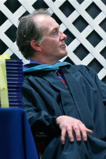 Assistant Principal Andrew Cavanaugh listens intently as Neil Lash, not shown, delivers the keynote address. (Photo by Ron Hawkes)