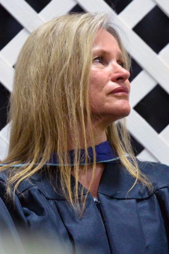 Assistant Principal Tamra S. Philbrook listens to a speech being delivered. (Photo by Ron Hawkes)