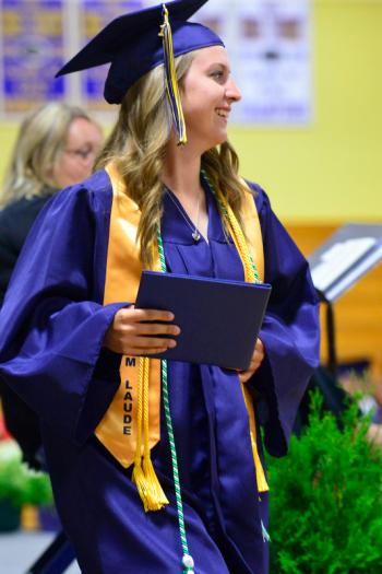 Lauren Nicole Guptill smiles as she holds up her diploma. (Photo by Ron Hawkes)