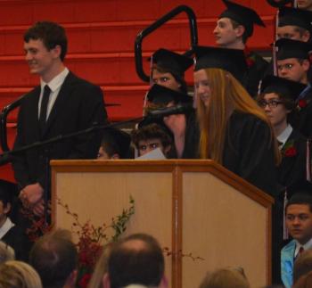 Class of 2015 President Mark McCluskey dons his ceremonial robe to lead the school next year, helped by Class of 2014 Senior Class Vice President Jaclyn Gilson. (Photo by Lynda Clancy)
