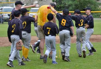 Fisher players, including Jason Leclerc, Ryan Lewis, Parker Hilchey, Jude Forti, Carson Murphy and Austin Pagano, among others dump bottles of Gatorade on manager John Murphy in the post-game celebration. (Photo by George Harvey)