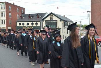 The Camden Hills Regional High School Class of 2014 marches through Camden’s downtown on the way to the First Congregational Church for the annual baccalaureate. (Photo by Lynda Clancy)