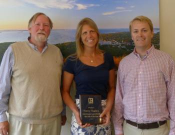 Shown here with Realtor of the Year Nancy Hughes are award presenter Sandy Ellsworth and local board president Brian Wickenden.