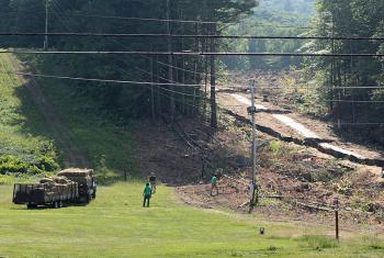 A Farley & Sons Landscaping crew delivers bales of hay to the Camden Snow Bowl, where additional erosion measures have been underway since last week. Inadequate erosion controls caused mud to flow into adjacent Hosmer Pond and turn it brown June 26. (Photo by Holly S. Edwards)