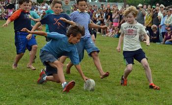 A group of boys chase the cheese down the Belfast Common hill Sunday during the 2014 Maine Celtic Celebration’s New World Cheese Roll Championship. (Photo by George Harvey)