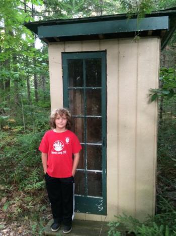 Wyatt stands by the moose shelter his dad built.
Photo by Dave Munson Wyatt Munson