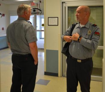 Pen Bay security guards brief each other in the changing of the guard. (Photo by Lynda Clancy)