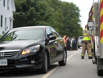 Emergency medical technicians and paramedics tend to 7-year-old Mia Davis on Camden late Tuesday afternoon, after she collided with a passing car while attempting to cross Turnpike Drive (Route 52) in Camden. (Photo by Holly S. Edwards)