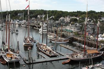 The schooner Heritage is pushed out of its overnight berth at the Camden town dock by its yawl boat, or tender, Saturday morning. (Photo by Holly S. Edwards)