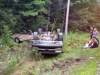 Robert Judkins of Waldoboro was towing a trailer loaded with totes of fresh picked wild Maine blueberries when he dozed off, crossed the centerline and went off the road. (Photo by David Edwards)