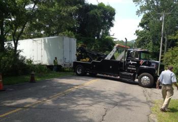 An 18-wheeler got stuck in a Camden farm field July 31, and a heavy duty tow truck was needed to pull it out. (Photo by Lynda Clancy)