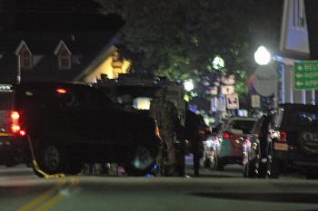 Tactical team members at the back of an armored vehicle during the overnight standoff on Route 1 in Camden. (Photo by Holly S. Edwards)