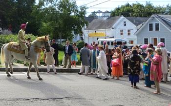 Family and friends of the groom, Johann, gather near the Rockport Public Library Saturday morning to lead him in the processional on foot to his wedding venue in the village’s Union Hall. (Photo by Richard Anderson)