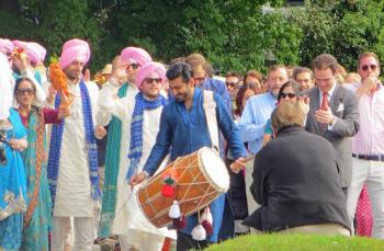 A drummer leads the processional of the groom and his family and friends to the wedding venue in Rockport Village Saturday. (Photo by Richard Anderson)