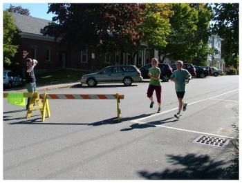 Runners cross the finish line at a 5K sponsored by WeCARE, Sept. 27. (Photo by Ethan Andrews)