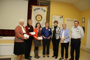From left to right are Elizabeth Moran of Camden-Rockport Historic Society, Sherry Cobb of Area Interfaith Outreach, Meredith Batley of Knox County Health Clinic, Jackie Harjula of Literacy Volunteers of Mid-Coast Maine, Camden Rotary Club President Jane Monhart, Felicity Bowditch of the Coastal Children's Museum, and Richard Householder, who heads the club's grant committee. (Photo by Peter Palermo)