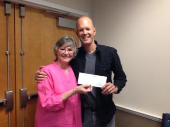 Sharon Lombardo, of the Lobster Festival benefactions committee, hands a check for $950 to Don Carpenter, executive director of Trekkers.