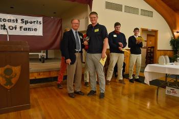 Charlie Crockett, left, presents Oceanside’s Nick Mazurek with the Male Athlete of the Year award from the Midcoast Sports Hall of Fame. (Photo by Ron Hawkes)