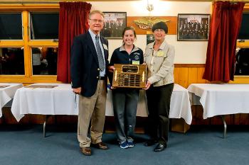 Erin Dugan, middle, stood in for her sister Brooke, who was starting her first college field hockey game Saturday and was unable to attend. Dugan is posing here with the Athlete of the Year sponsors, Charlie and Penny Crockett of C2 Productions. (Photo by Ron Hawkes)
