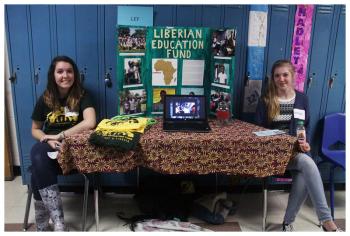 Lucie Bonneville and Hannah Greene at a table for the student-run Liberian Education Fund. (Photo by Charles R. Hamm)