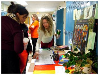 Open house attendees stop by the foreign language department display. (Photo by Ethan Andrews)