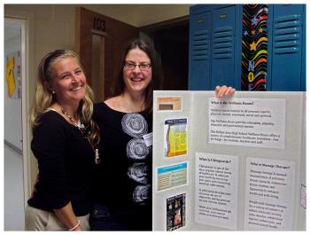 Chiropractor Jane Robertson, left, and massage therapist Kristen Burkholder present information on the high school’s wellness program. (Photo by Ethan Andrews)