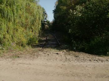 The tracks of the old Belfast & Moosehead Lake Railroad end abruptly at the old Upper Bridge crossing, the area designated as one end of a planned recreational trail along the Passagassawakeag River. Workers started removing the rails this week along a two-mile stretch of the city-owned corridor. (Photo by Ethan Andrews)