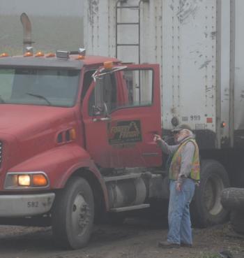 Talking with Thompson Enterprises before the tractor trailer hauls the 20,000 tons of chips away. (Photo by Lynda Clancy)