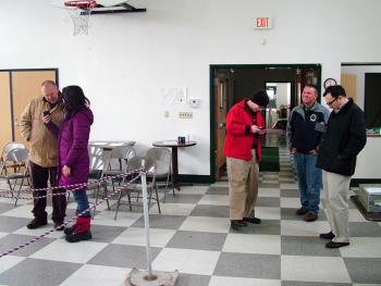 State Senator Michael Thibodea (R-Winterport), second from right, and challenger Jonathan Fulford (D-Monroe), far left, wait with supporters at the Waldo town office, Wednesday, Nov. 6. Due to storm damage, the office had no heat or power. Poll workers closed shop Tuesday night and returned on Wednesday to hand count the last of the county’s ballots. (Photo by Ethan Andrews)