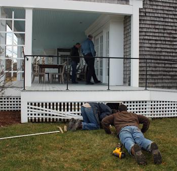 The deck under which the fox and Lucy ended up, and where Evan Drinkwater discovered them in an old foundation hole. Two rows of lattice blocked the cement foundation wall, over which only a small dog and a fox could breach with the deck still in place above. (Photo by Holly S. Edwards)